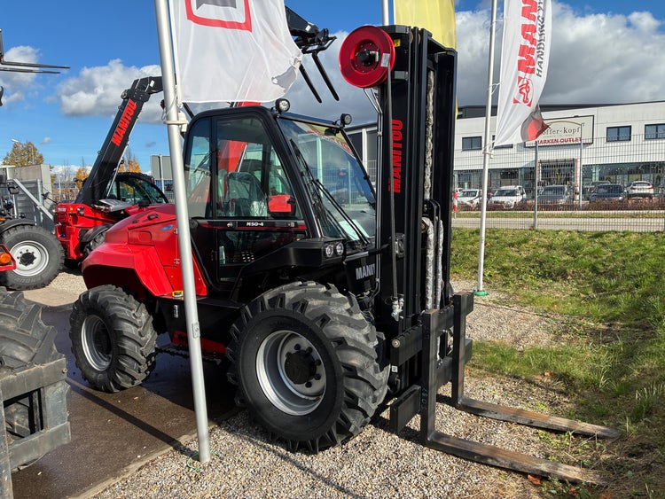 Roter Manitou Geländestapler M50-4 mit Gabelzinken auf dem Ausstellungsgelände