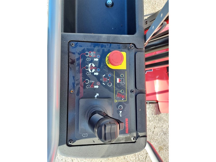 Steuerkonsole auf der Plattform der Manitou Hubarbeitsbühne mit Joystick, Not-Aus-Schalter und Bedienungssymbolen.